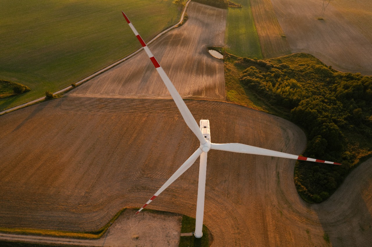 A elecric windmill in a rural land